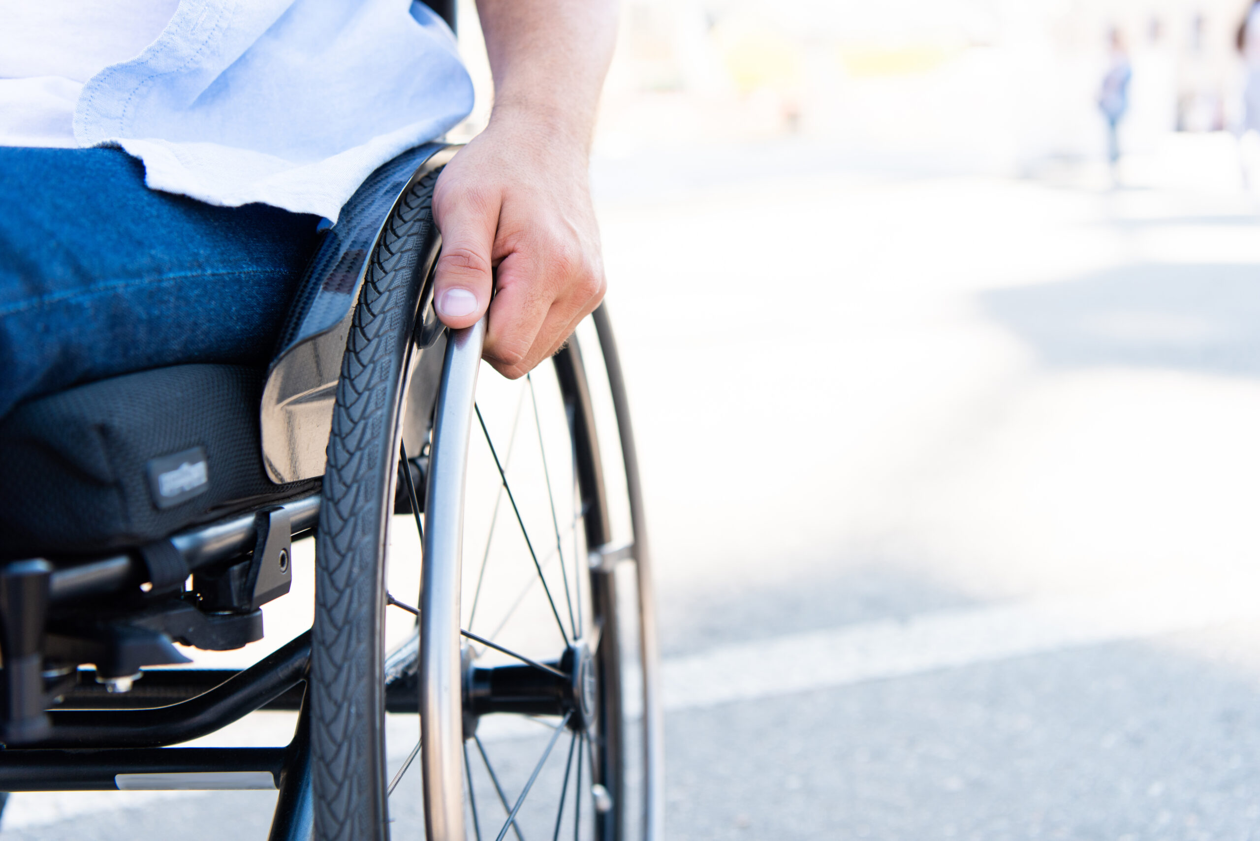 Man using a wheelchair in a parking lot