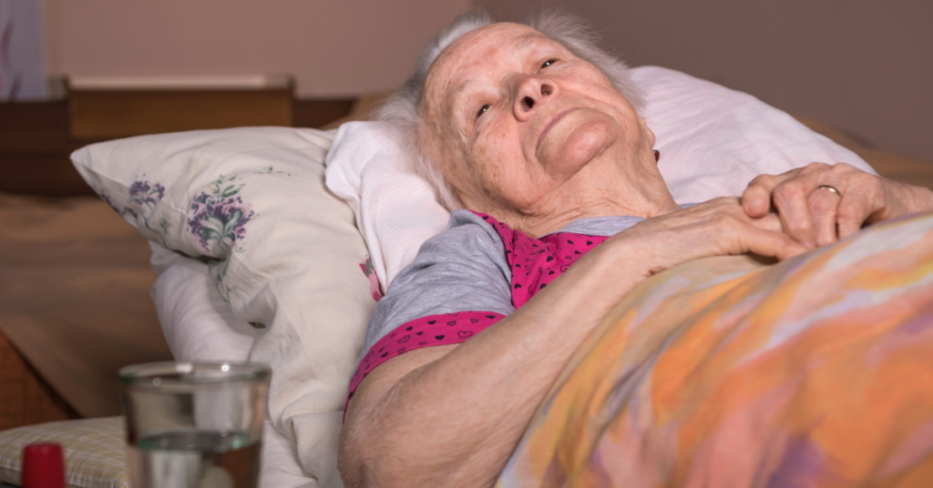Elderly woman lying in bed