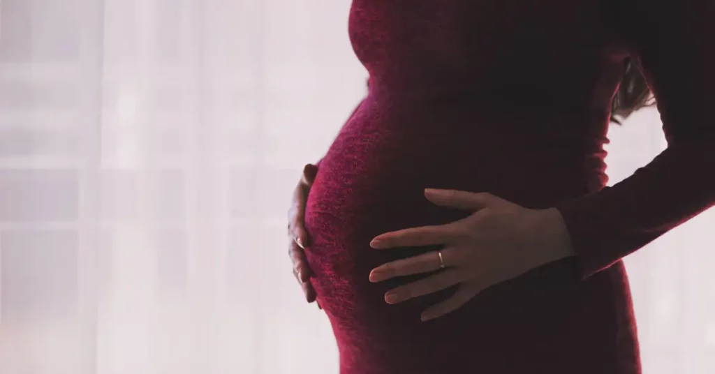 pregnant woman holding her belly
