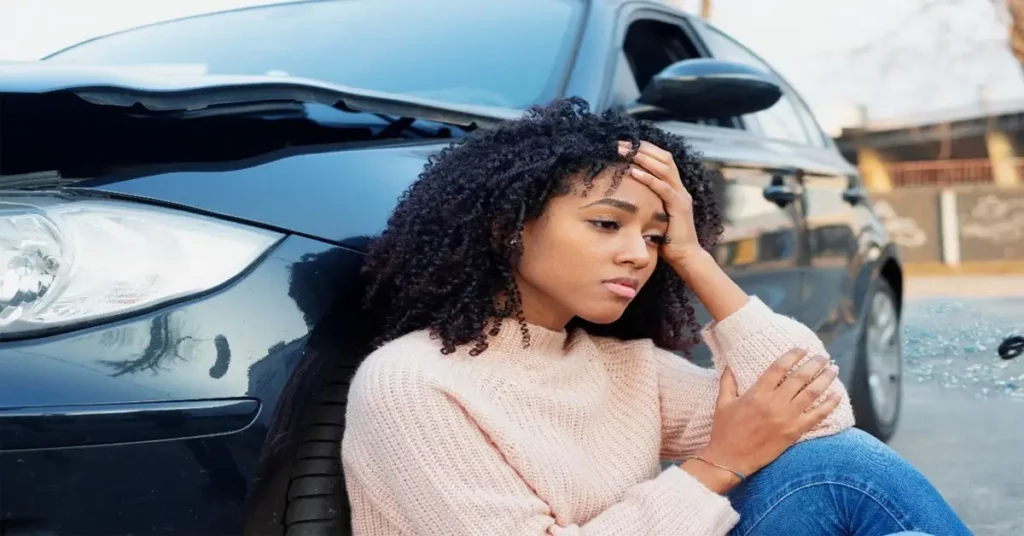 Upset woman resting after a car wreck