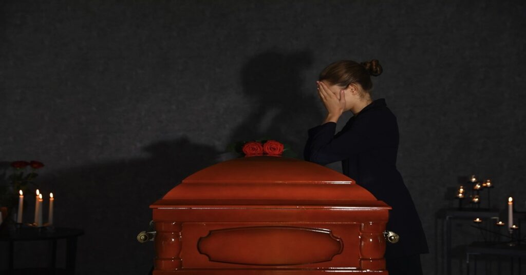 Woman mourning her loved one at a funeral