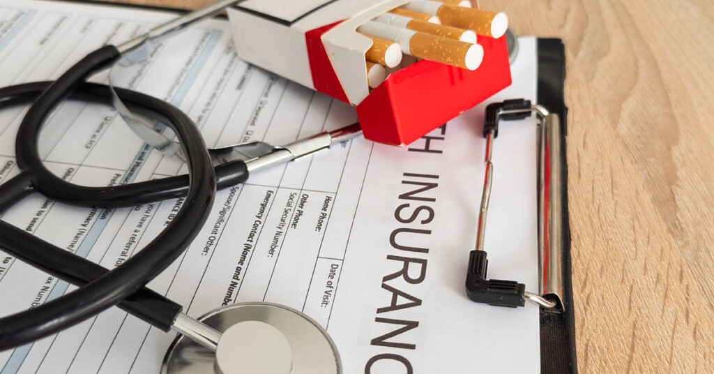 A clipboard showing health plan tobacco surcharges