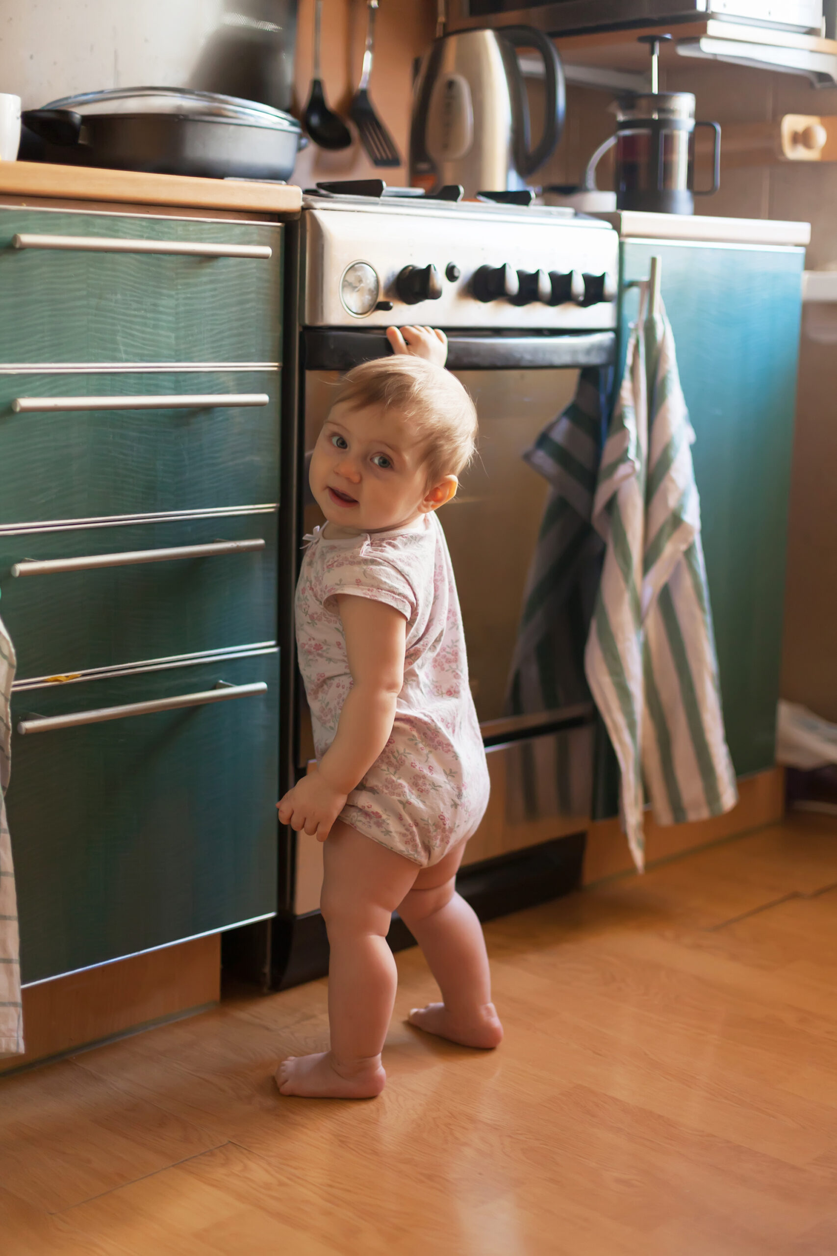 Child near a kitchen stove.
