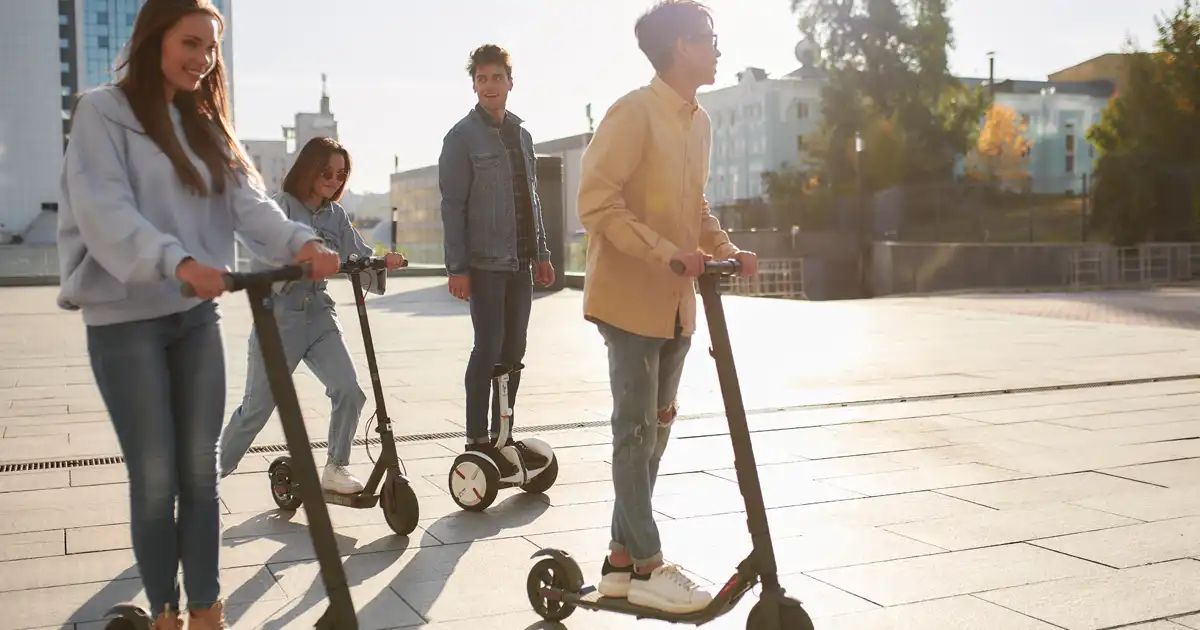 image of young people riding a segway and scooters