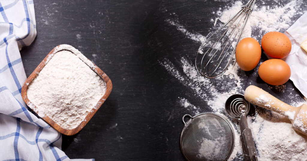 image of a table top full of baking supplies including flour and eggs