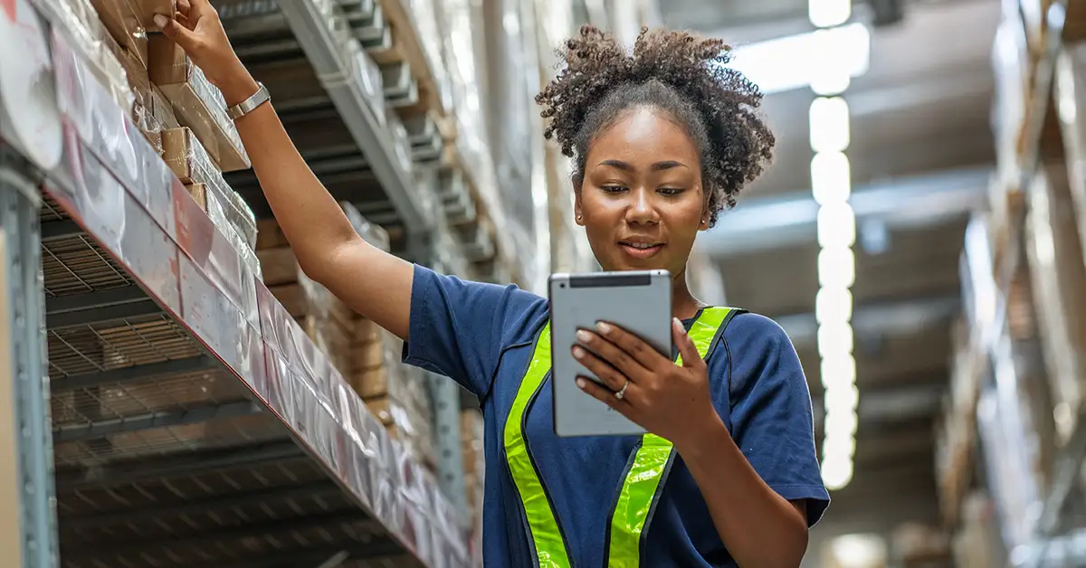 image of a female box store worker on ladder taking inventory
