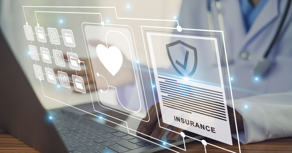 image of a virtual compute screen hovering over a laptop with health insurance symbols
