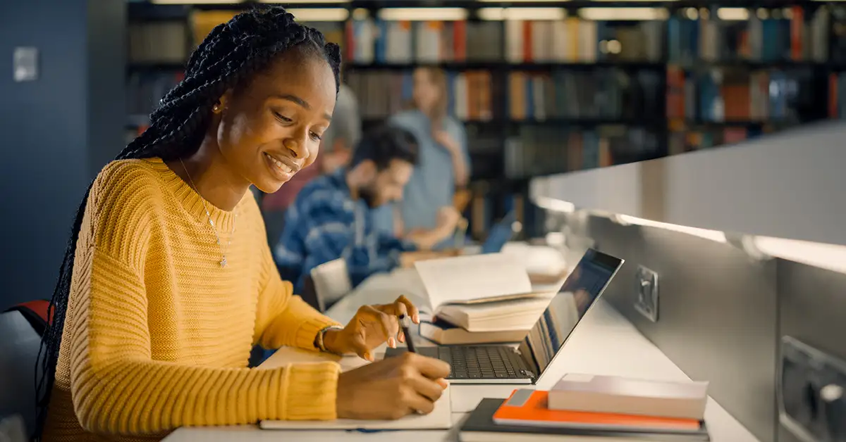 image of a college student at the library